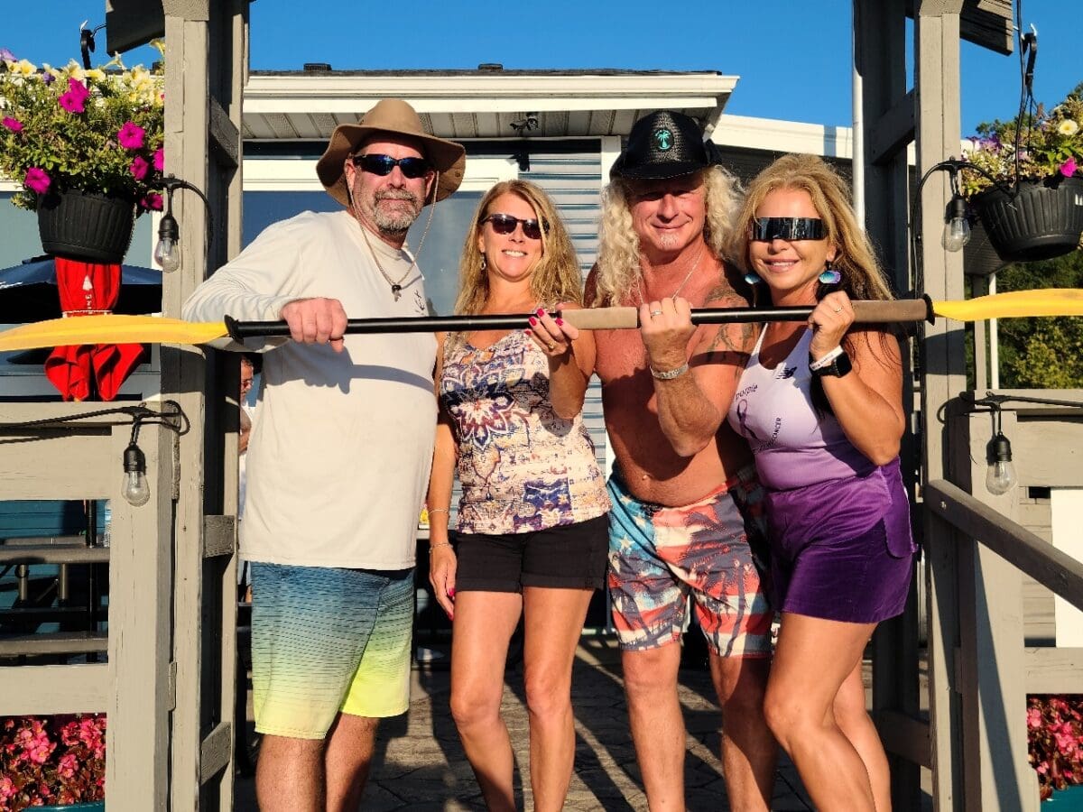 Club friends gathered outdoors with paddles